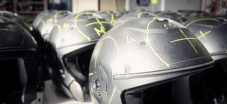 Casques de moto alignés avec marquages jaunes.